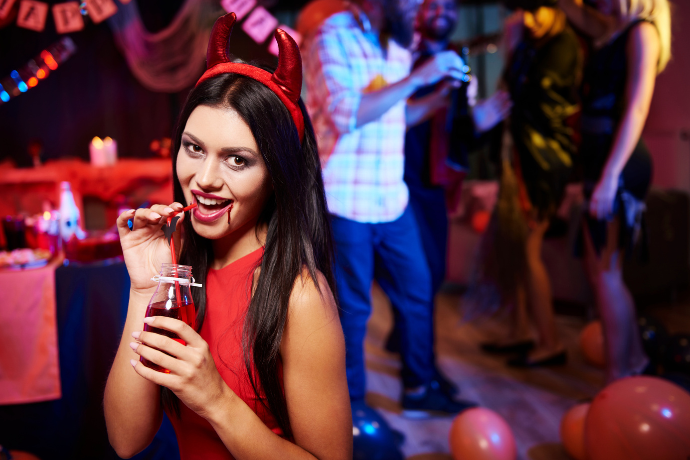 Woman drinking a red drink